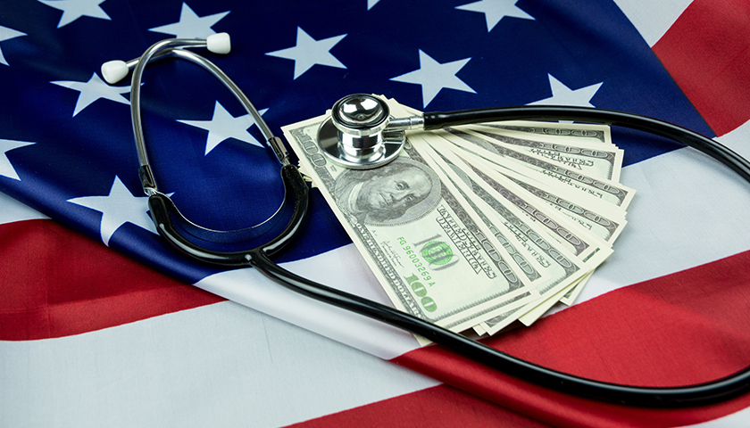American flag with $100 bills and stethescope