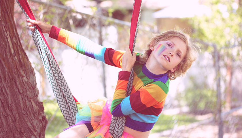 Bink, a gender non-conforming 10 year old child playing outside.