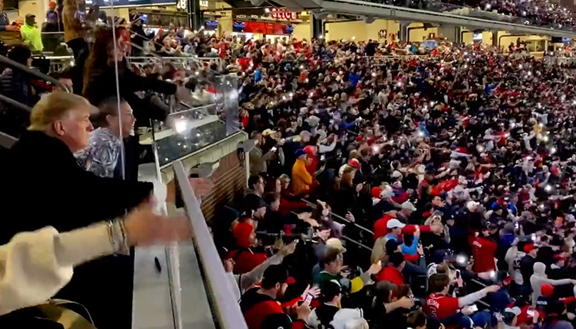 Donald Trump and crowd at the MLB Braves World Series game, doing the tomahawk chop