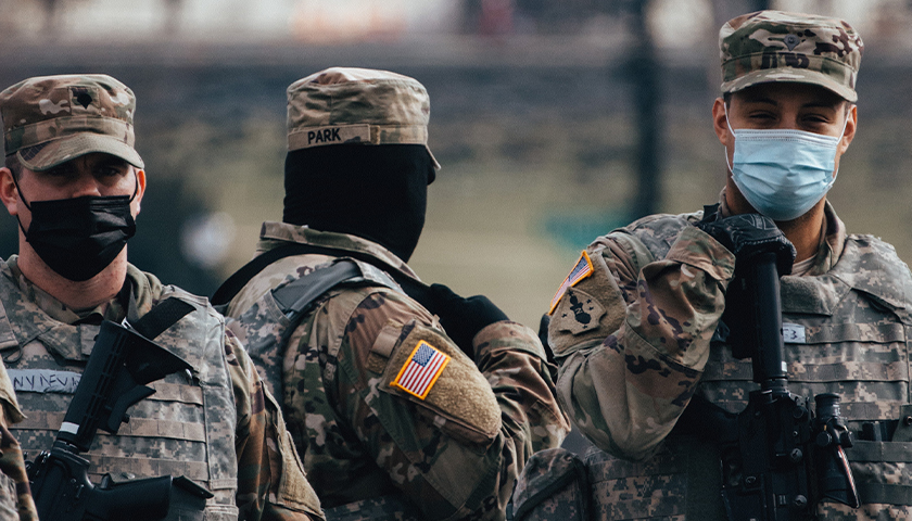 National Guard members in uniform, wearing masks