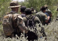 Four illegal aliens apprehended in dense brush by members of the U.S. Border Patrol Search, Trauma, and Rescue (BORSTAR) team are led to awaiting vehicles near Eagle Pass, Texas, June 19, 2019. As Border Patrol agents are tasked to conduct intake and processing of the recent surge in migrant arrivals at the border, members of BORSTAR have been assisting in pursuing illegal aliens afield. CBP photo by Glenn Fawcett